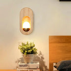 Vue frontale de l’applique murale en bois clair avec lumière allumée.
