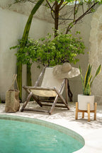 Chaise longue pliante en bois avec toile claire pour le cache-pot en terre cuite et teck