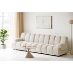 Canapé modulaire crème en peluche avec coussins ronds segmentés et design minimaliste moderne