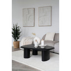 Table basse ovale noire aux pieds cylindriques épais