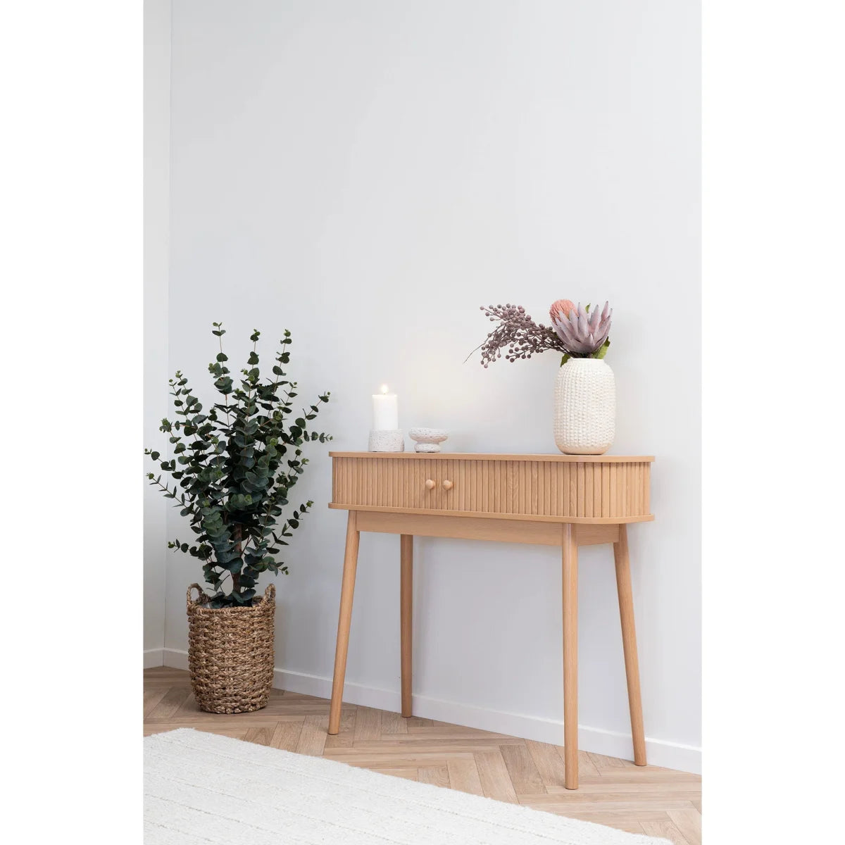 Table console en bois clair, tiroir unique, pieds fins et lattes verticales