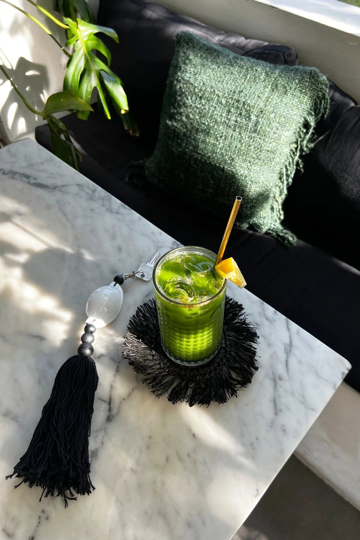 Mojito menthe verte avec quartier de citron vert et paille dorée dans verre clair