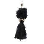 Porte-clés pompon noir en coton avec fermoir argenté et coquillages cauris