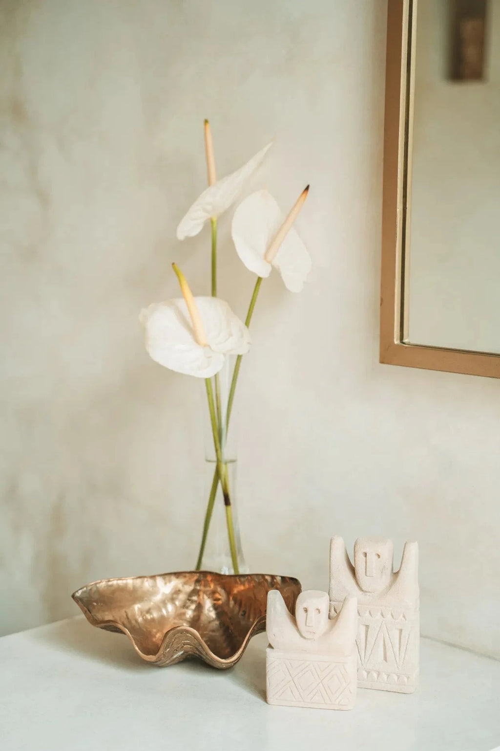 Trois fleurs d’anthurium blanches dans un vase en verre pour la statue en grès sculptée main