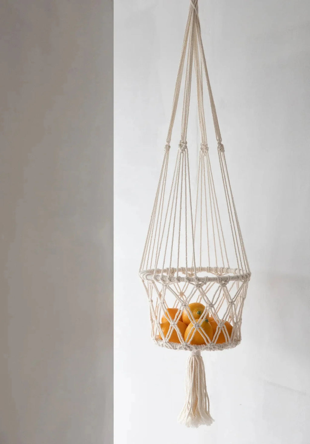 Suspension plante macramé en coton blanc cassé avec franges tenant plusieurs oranges