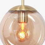 Suspension en verre ambre sphérique avec top en laiton et ampoule à filament exposé