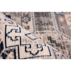 Tapis oriental à poil ras avec motifs géométriques en bleu, gris et crème
