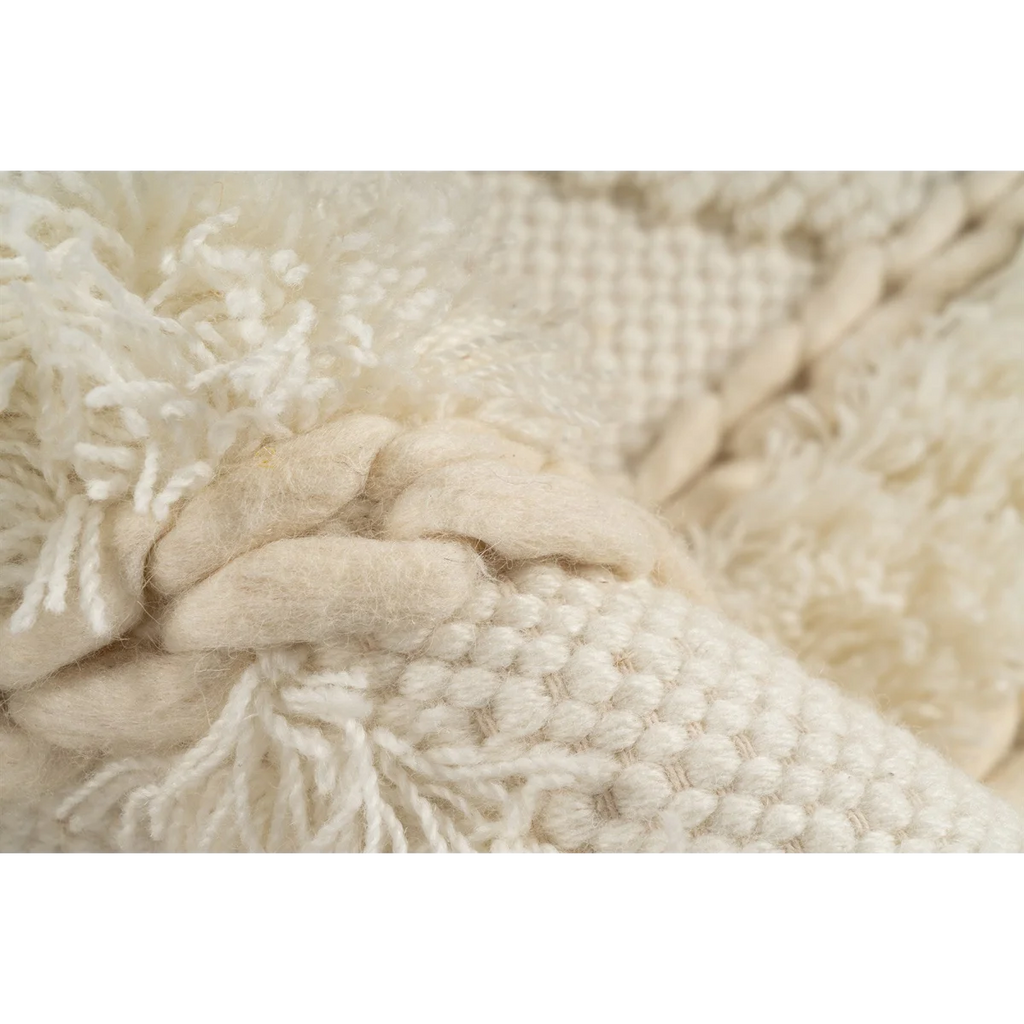 Tapis rond en laine crème avec motifs géométriques texturés et tissage varié