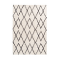 Tapis shaggy rectangulaire écru avec motifs losanges noirs pour salon moderne