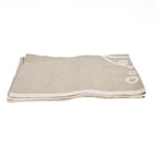 Torchon en lin naturel beige plié avec motif poisson blanc écru