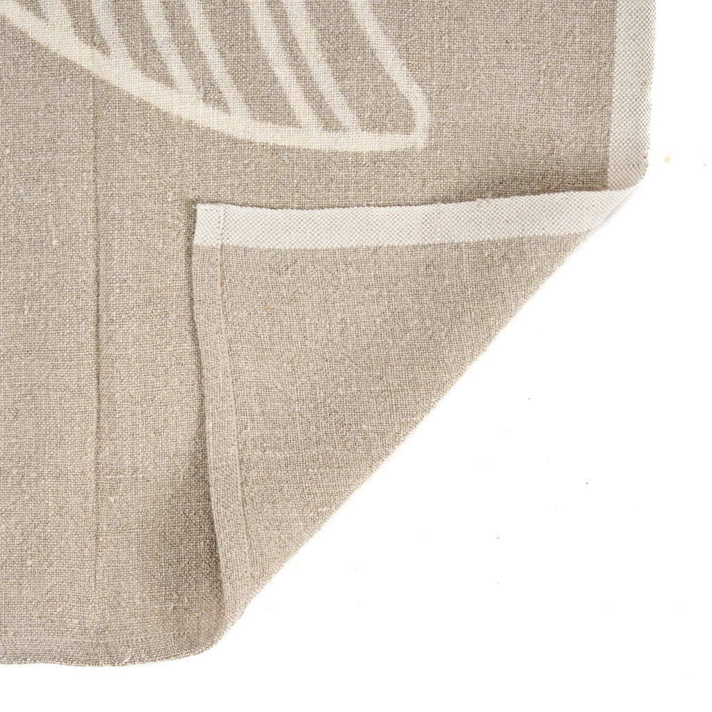 Tapis en lin naturel beige avec motif feuille blanc subtil