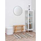 Miroir rond blanc à cadre noir fin dans vitrine étroite en métal blanc 140 cm